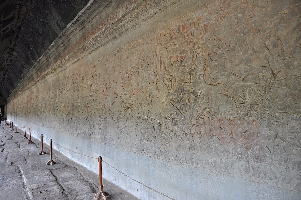 One of the temple's famed bas-relief galleries, carved directly into the sandstone walls with battle and mythological scenes.