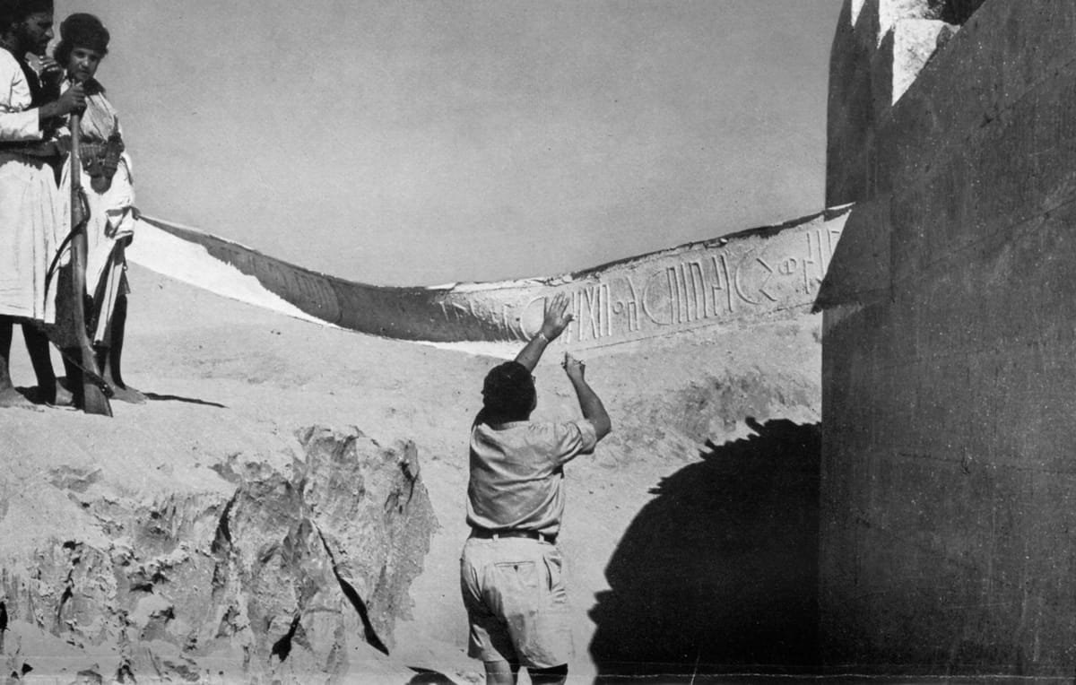 A member of Wendell Phillips' 1951-52 American Foundation for the Study of Man expedition copies a Sabaic inscription from the sanctuary's exterior wall.