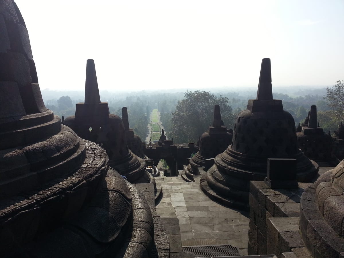 An aerial view showing the monument's full stepped-mandala footprint, with its nine stacked platforms and rings of perforated stupas.