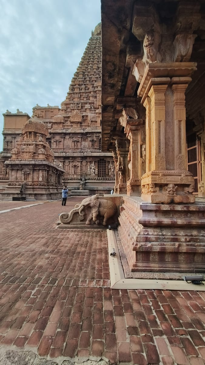 The vimana seen from within the temple courtyard, giving a sense of its scale against the surrounding structures.
