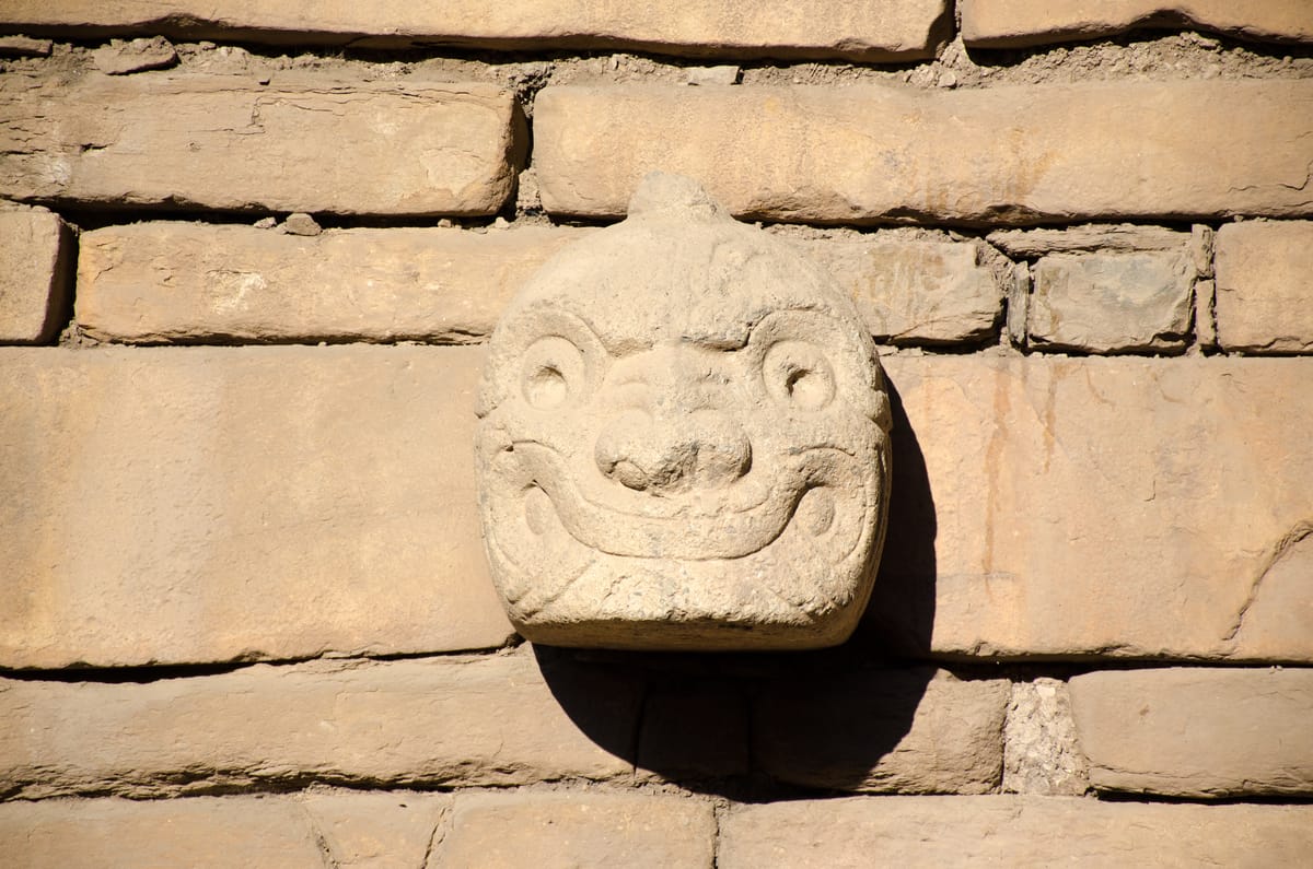 A cabeza clava, one of the carved stone tenon-heads that once studded the exterior walls of the temple.