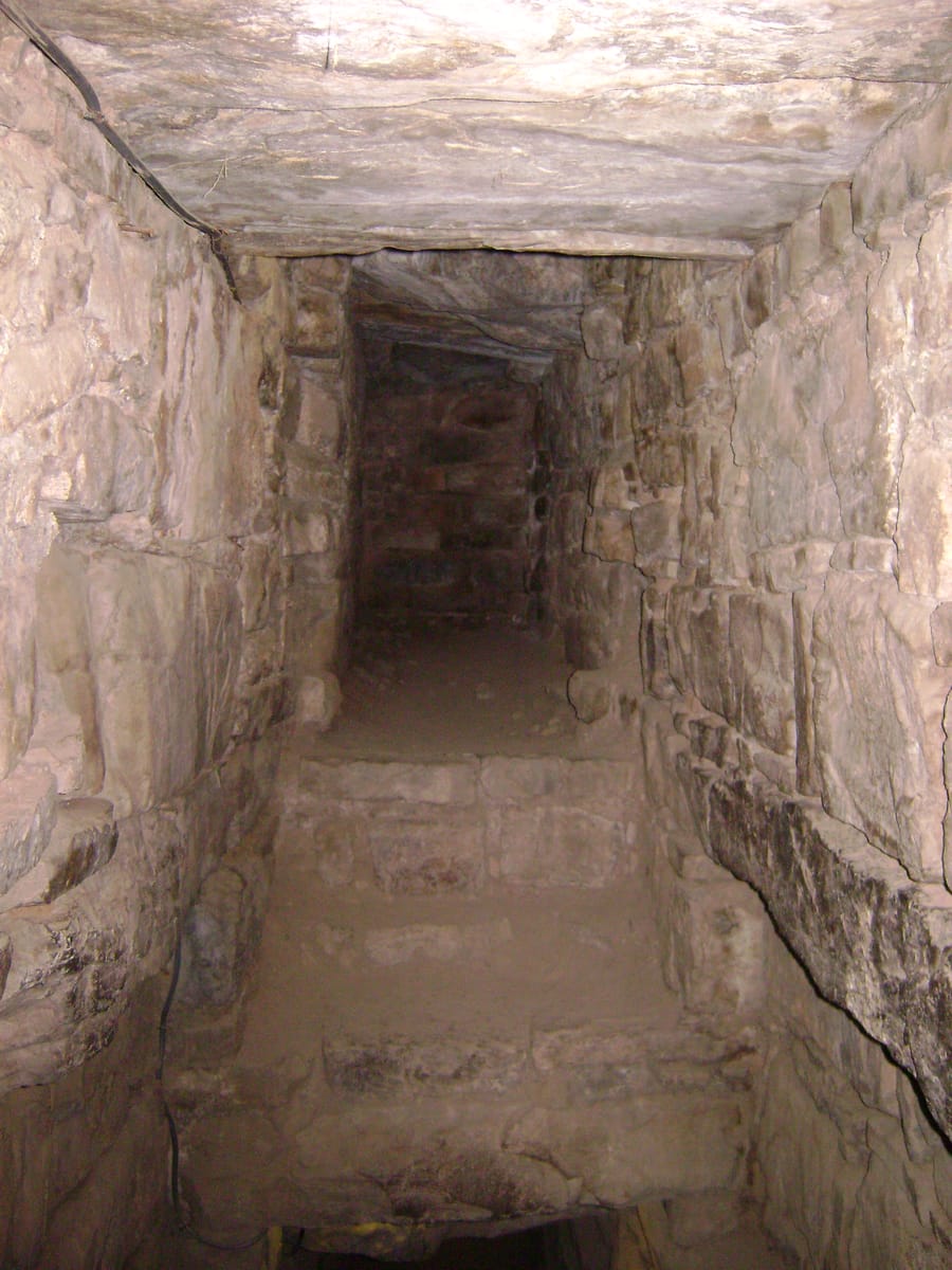 One of the narrow, stone-lined interior galleries honeycombing El Castillo, part of the temple's internal labyrinth.