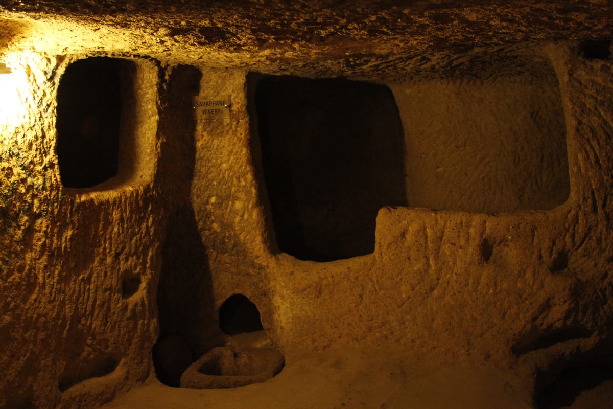 A carved winery chamber inside Derinkuyu, used for pressing grapes underground.