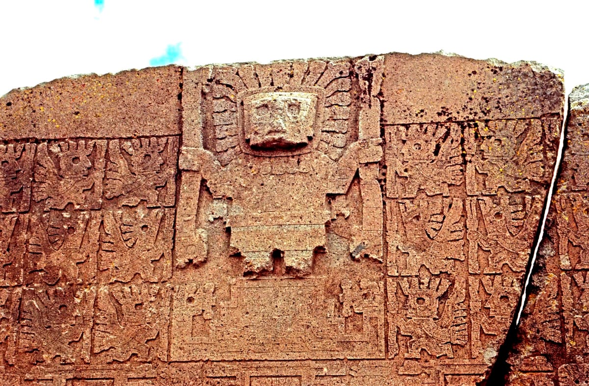 Detail of the Gate of the Sun's carved frieze: the central rayed 'Sun/Staff God' holding a staff in each hand, flanked by rows of winged attendant figures.