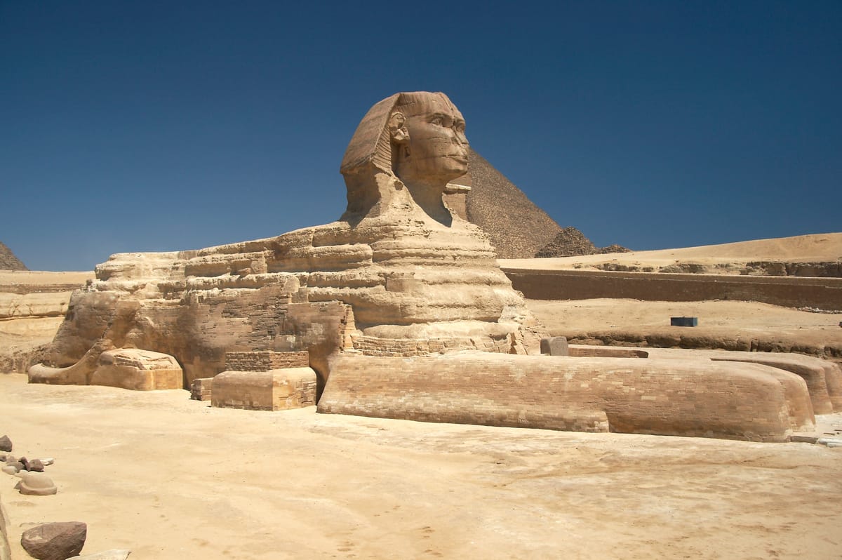 The Sphinx with the Pyramid of Khafre behind it. The statue sits at the head of Khafre's causeway, beside his Valley Temple, at the edge of the quarry from which much of the Giza necropolis was cut.