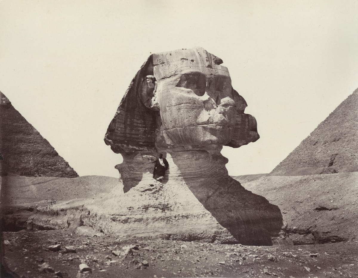 The Sphinx photographed by Félix Bonfils around 1888, still buried to the shoulders in wind-blown sand. For most of its history only the head stood above the desert; full excavation was not completed until the 1930s.