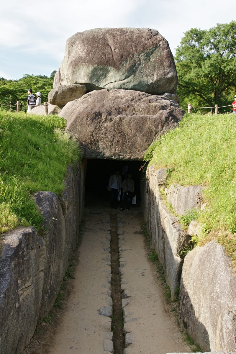 The entrance passage, with its stone-cut drainage channel running down the centre toward the chamber mouth.