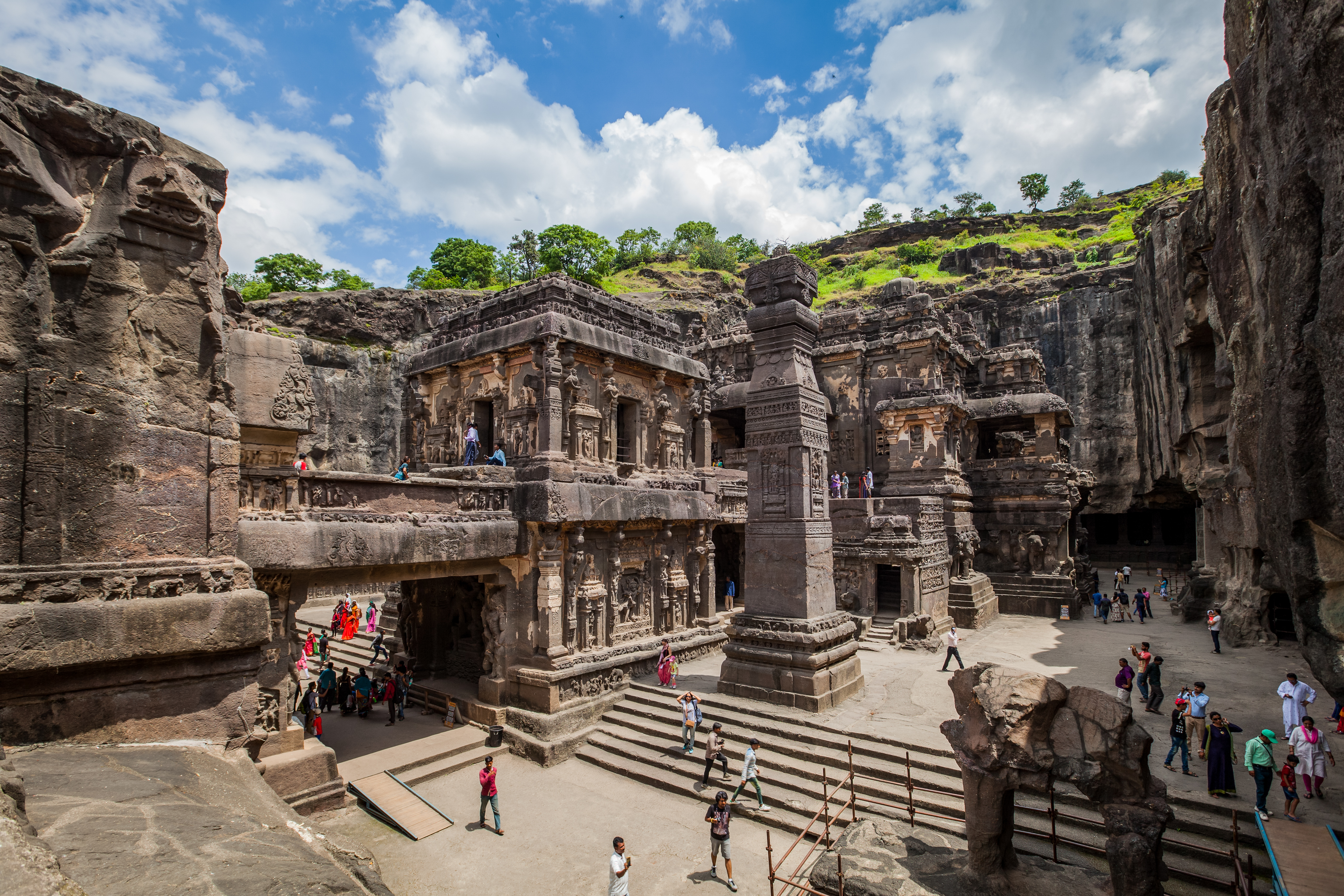 A wide view of the excavated courtyard, showing the scale of the pit cut around the freestanding temple.