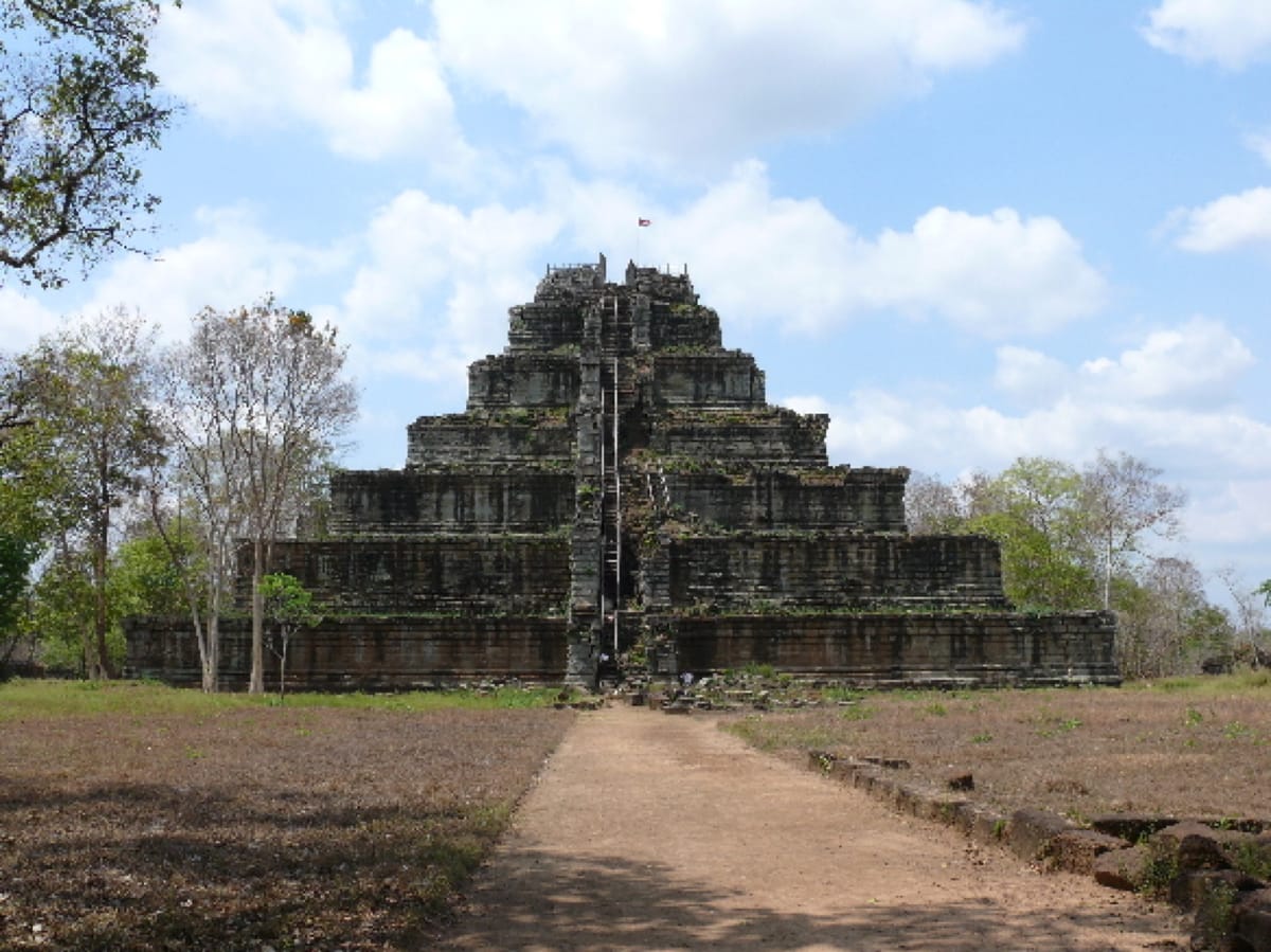 Prasat Thom seen from the approach path, its stepped profile rising abruptly out of the surrounding scrub forest that has reclaimed much of Koh Ker since the 10th century.