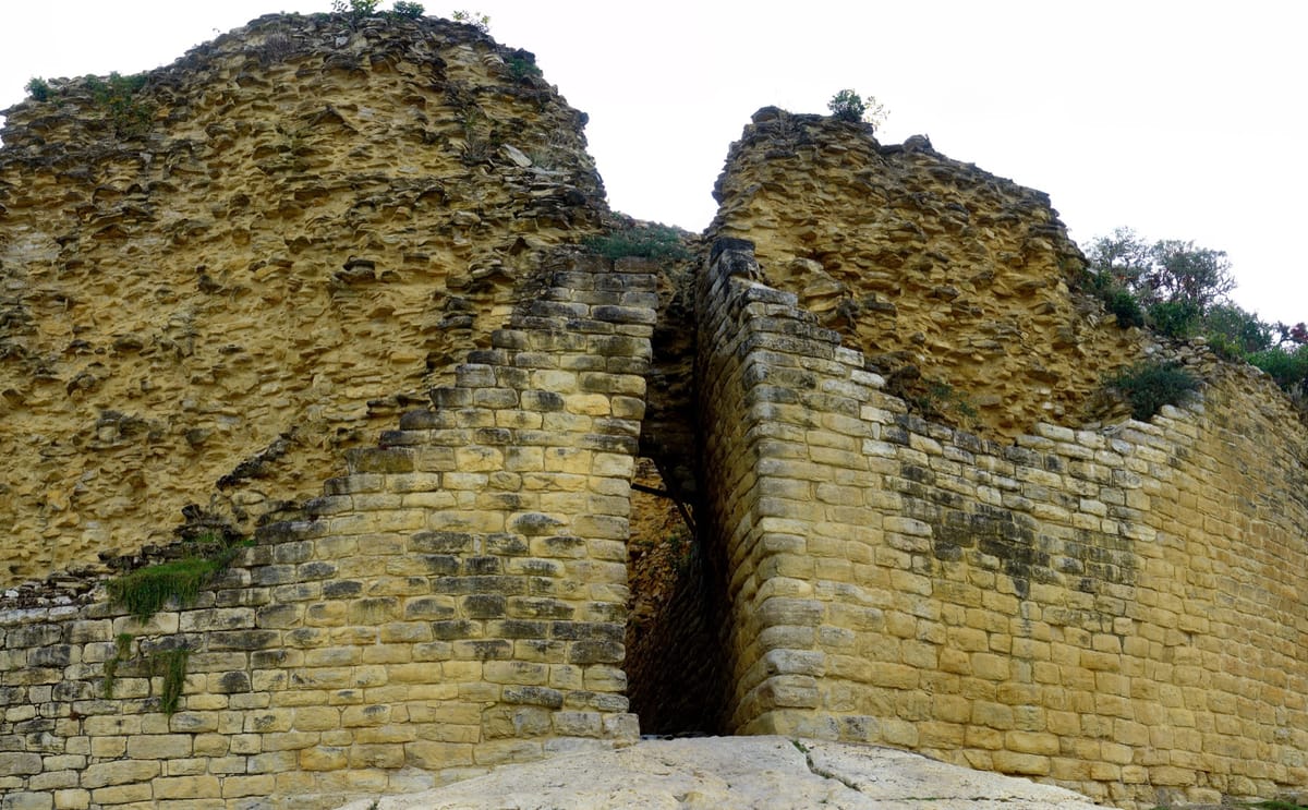 One of Kuélap's three entrances: a passage between towering walls that narrows as it climbs until only a single person can pass at a time.