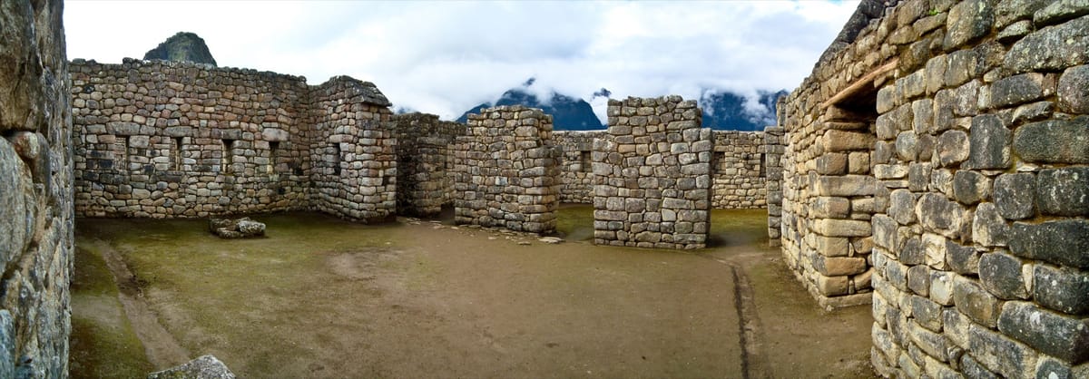 Interior walls of the finest Inca ashlar masonry at Machu Picchu, where dressed granite blocks are fitted without mortar into mutually locking joints.