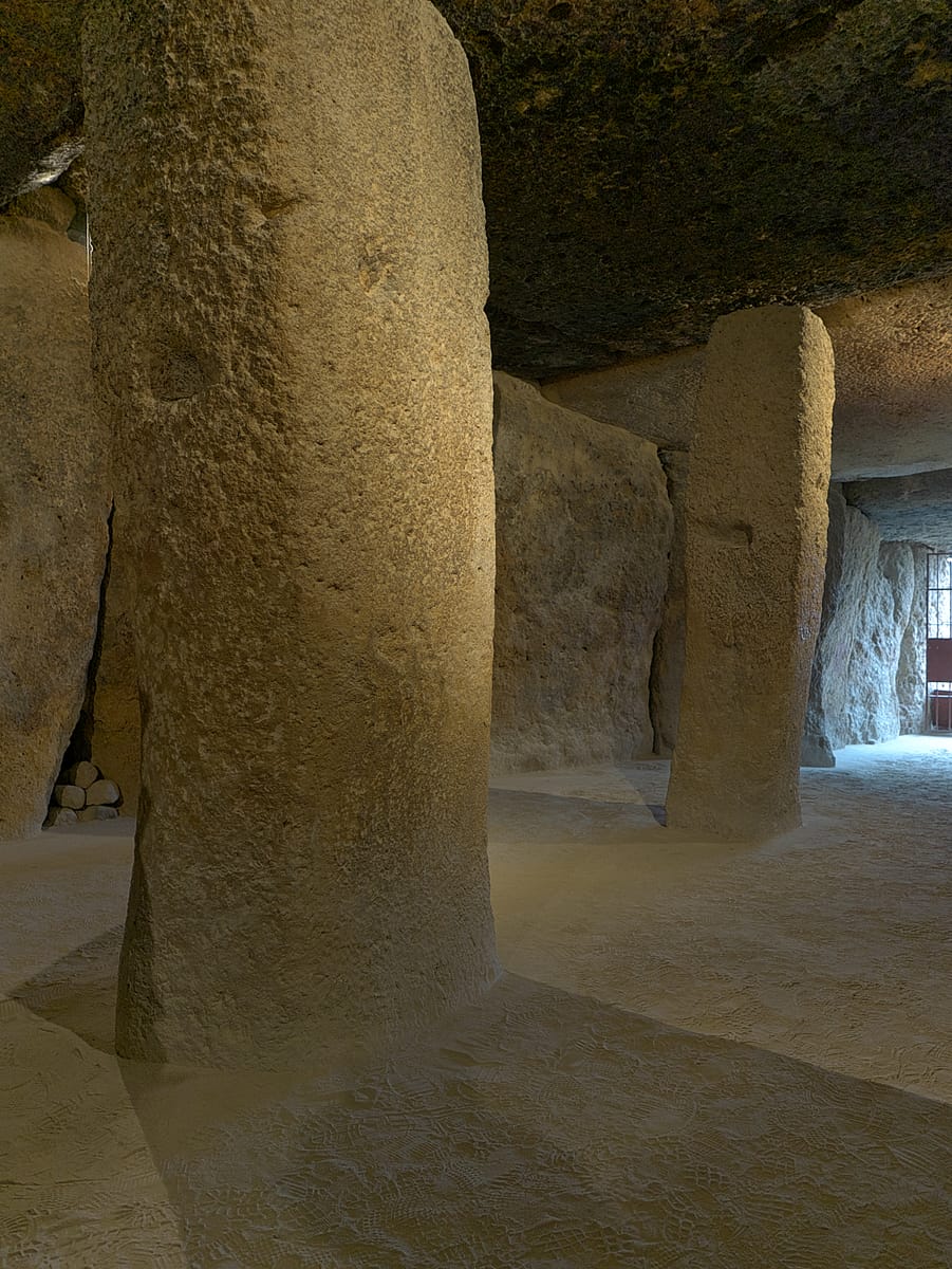 Close view of the upright orthostat stones forming the chamber walls.