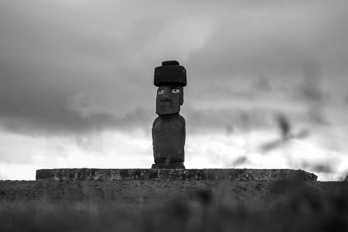 The restored moai at Ahu Ko Te Riku, Tahai, the only moai on the island fitted with reconstructed coral-and-obsidian eyes and a red scoria pukao (topknot).