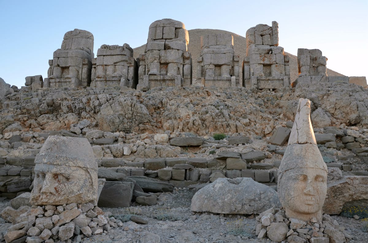 The East Terrace, with the row of enthroned statue bodies behind and their giant heads set on the ground in front of them.