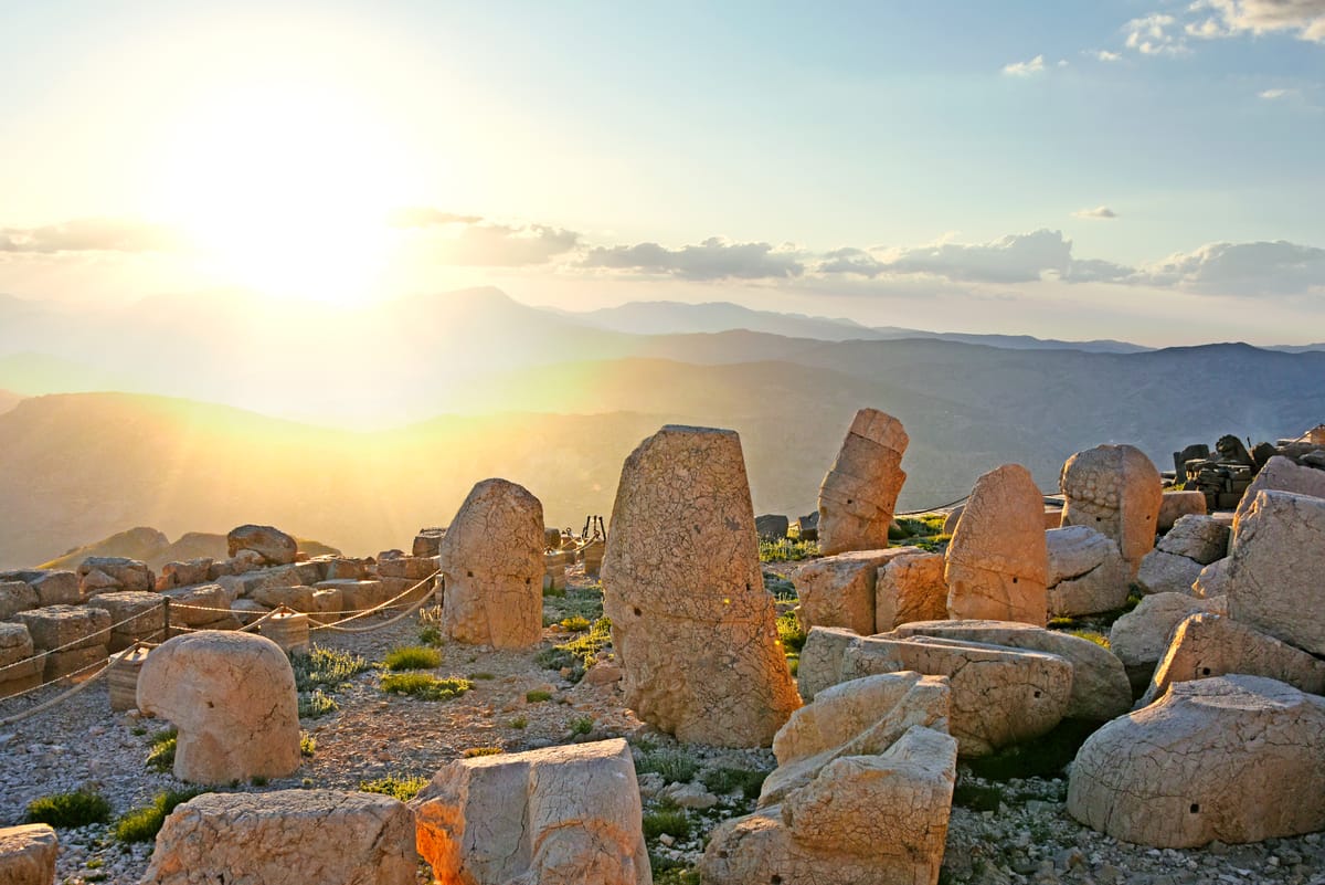 The summit tumulus at sunset — a roughly 50-metre cone of crushed rock heaped over the presumed, never-located tomb.