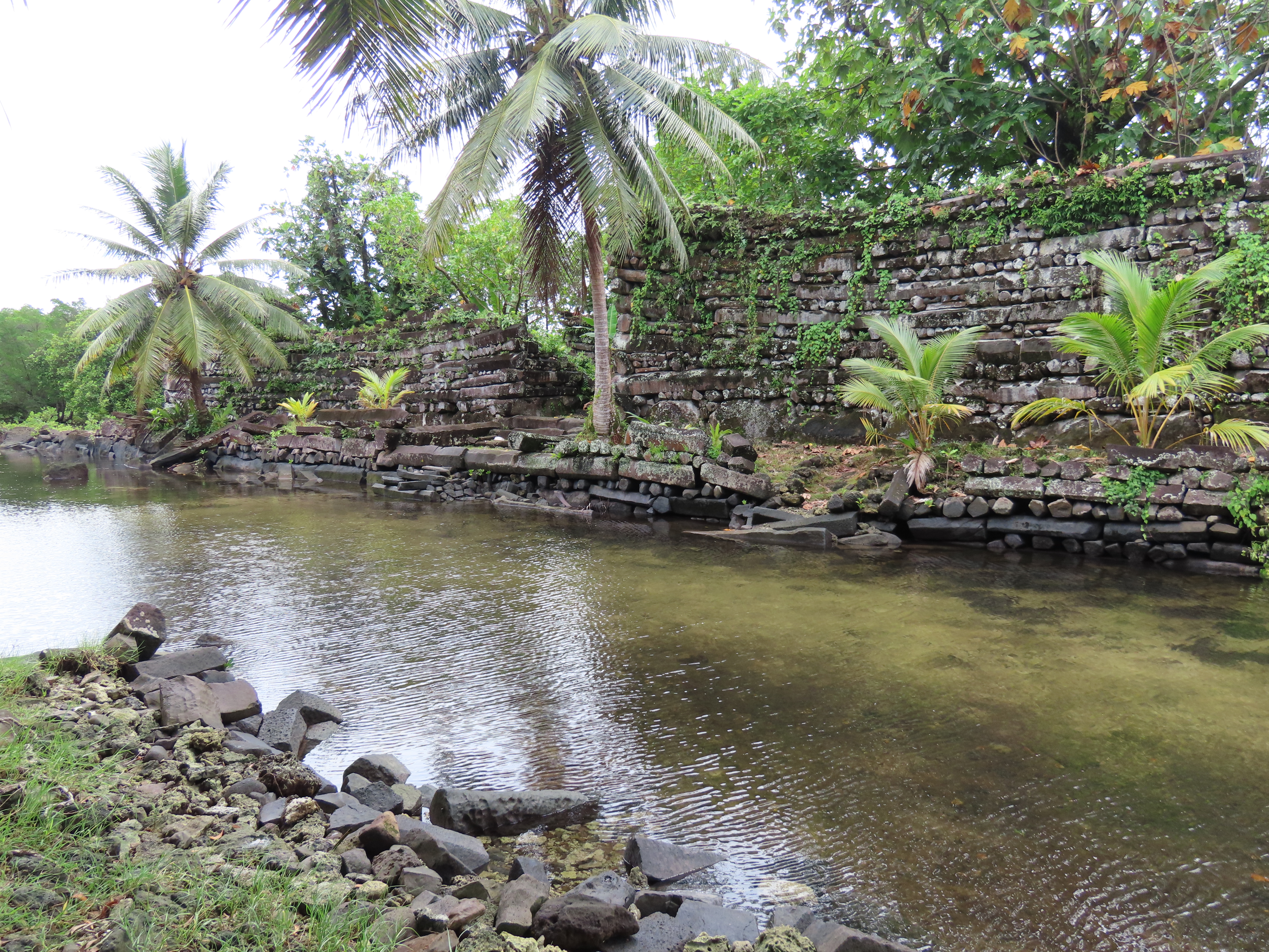 A tidal canal running between islet walls — the waterways that gave Nan Madol its nickname, the 'Venice of the Pacific.'