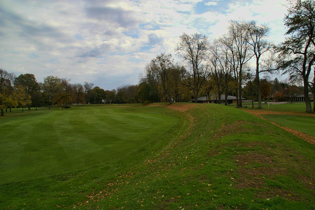 A long, low embankment wall of the Octagon Earthworks. From 1910 until 2025 this precisely aligned monument lay beneath a private golf course, which preserved the earth even as it restricted access.