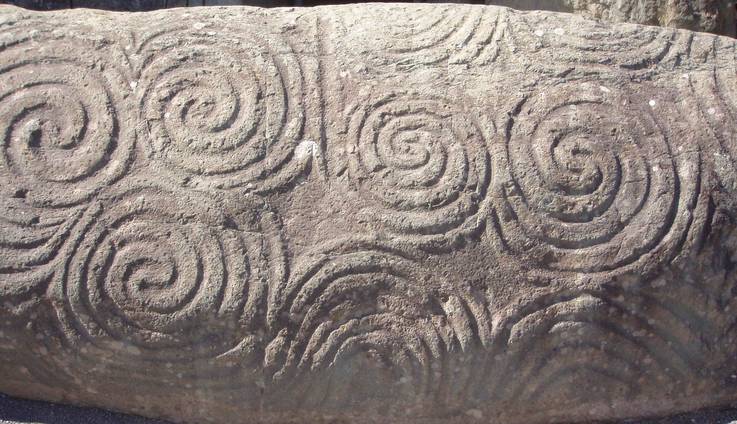 Kerbstone K1, the entrance stone, carved with its famous triple-spiral (triskele) motif.