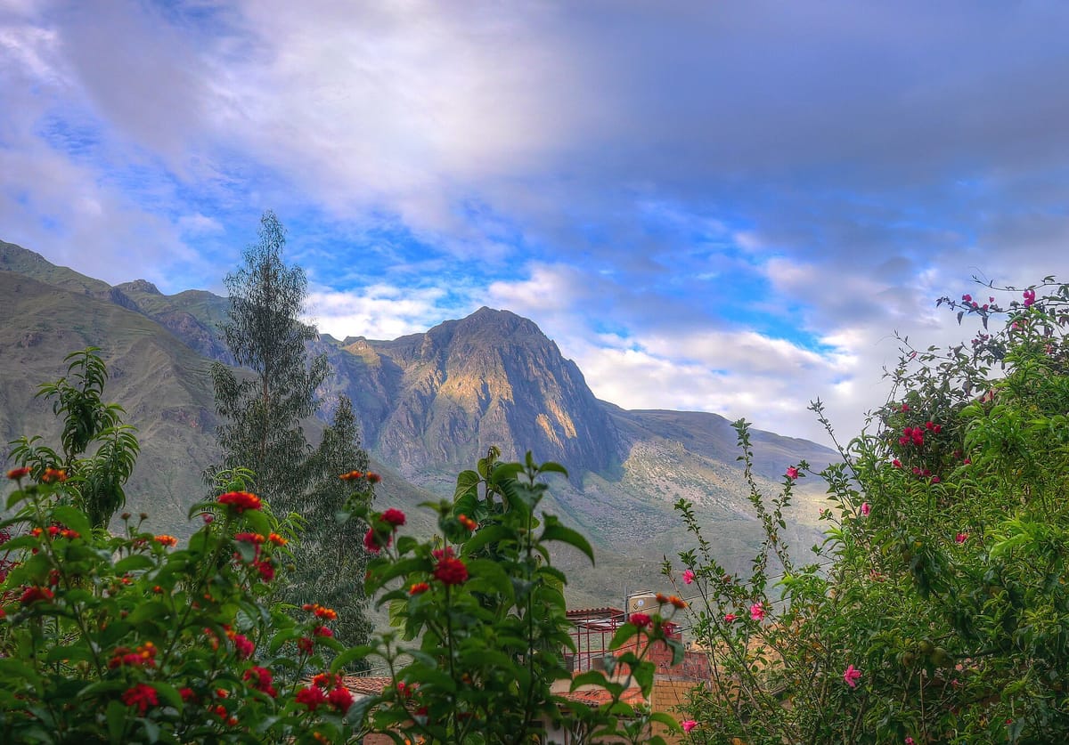 View toward Yana Urqu mountain, across the Urubamba River from Ollantaytambo, where the Kachiqhata quarries supplied the temple's rose rhyolite.