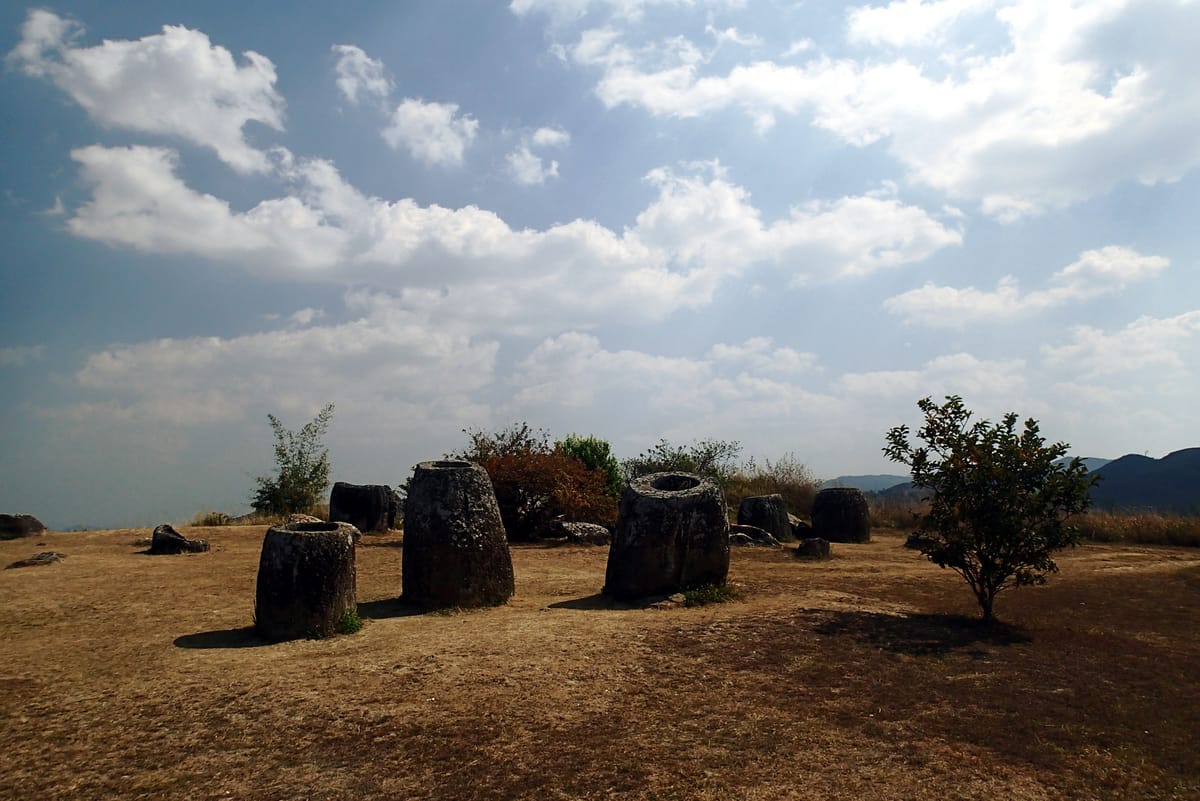 A cluster of jars on an open hilltop. Individual sites range from a single vessel to several hundred, spread across the plateau's valleys and ridges.