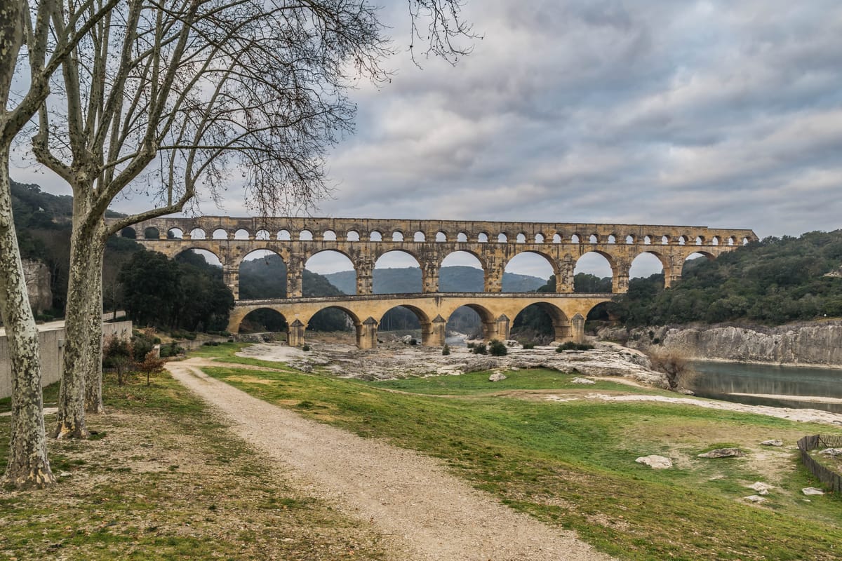 The downstream face of the bridge: six arches on the lowest tier, eleven on the second, and the long arcade of the third, which carries the enclosed water channel.