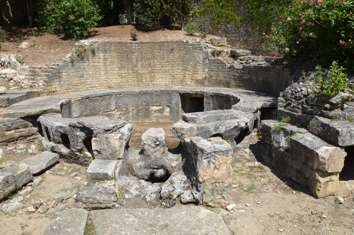 The end of the line: the castellum divisorium at Nîmes, the circular distribution basin where the aqueduct's water arrived and was split between ten outlet pipes feeding the Roman city.