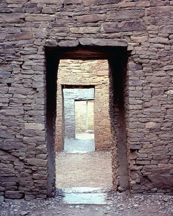 A row of aligned doorways at Pueblo Bonito, connecting successive rooms in a single sightline.