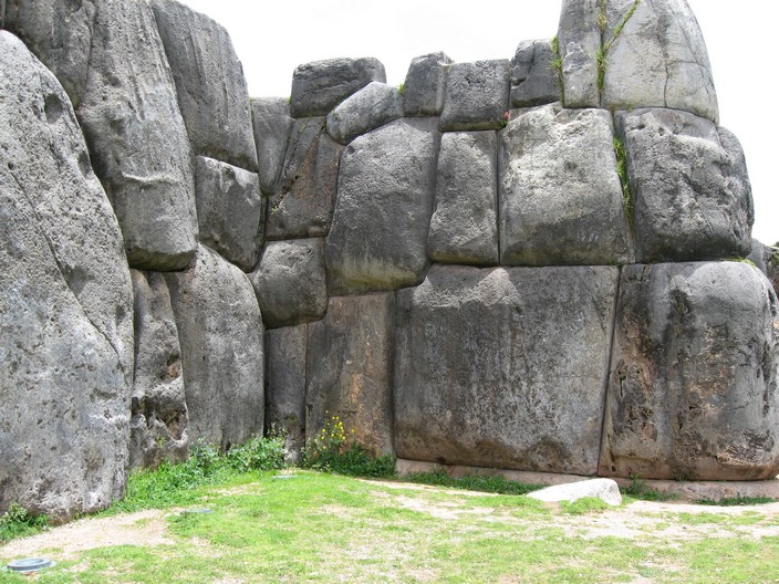 Close-up of the massive polygonal stone blocks in Sacsayhuamán's walls, interlocked without mortar.