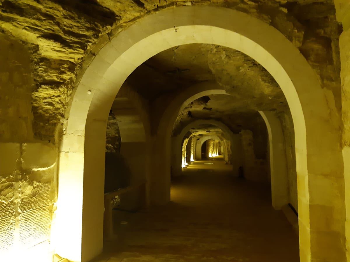 The main gallery of the Serapeum, a long rock-cut tunnel lined with side chambers cut for individual sarcophagi.