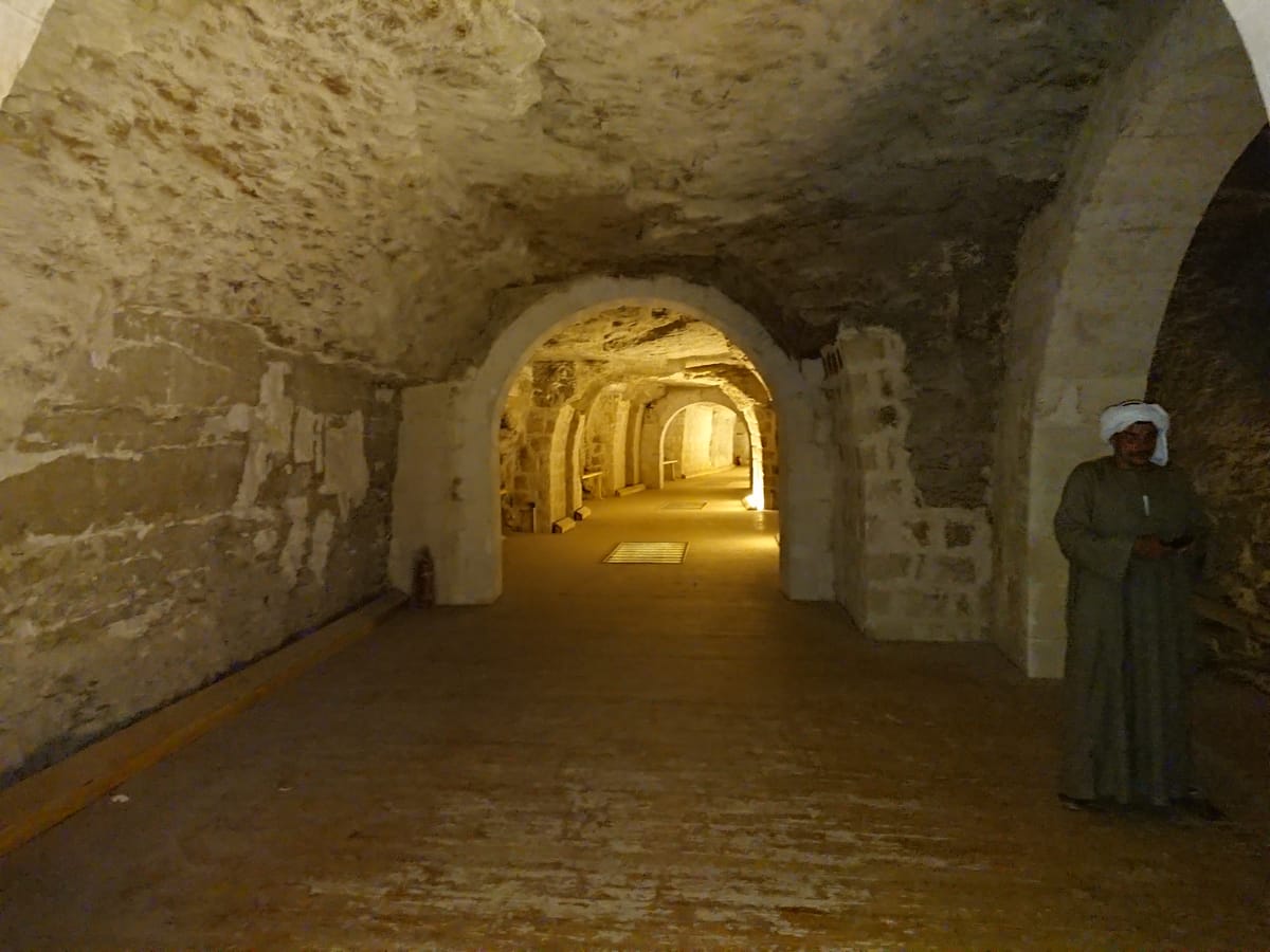 A corridor of the underground galleries, cut directly into the bedrock beneath the Saqqara plateau.