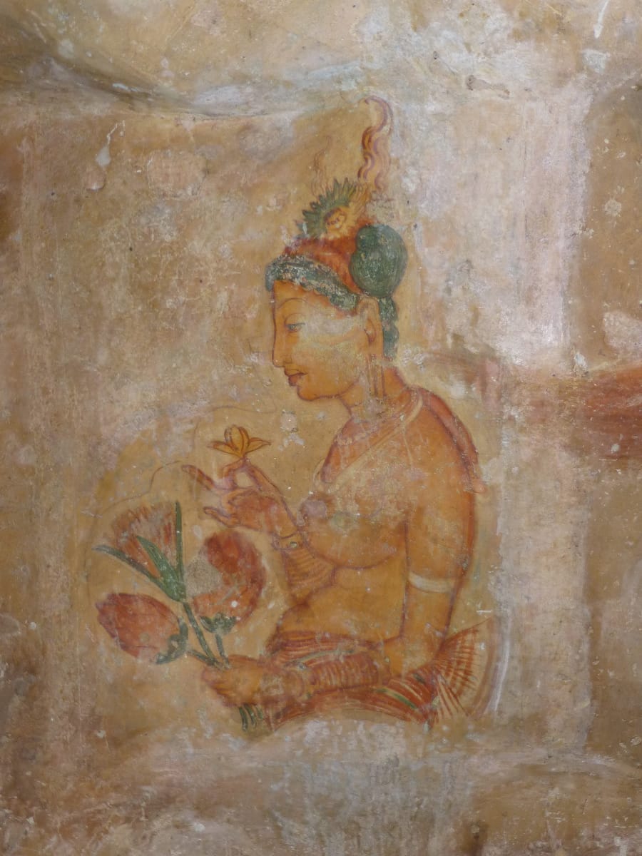 One of the surviving frescoes on the sheltered western rock face, part of the group popularly known as the 'Sigiriya damsels.'
