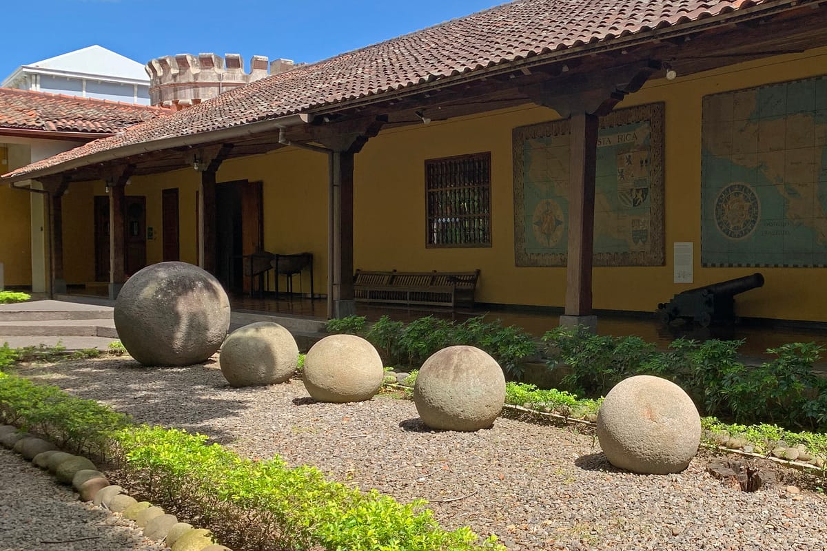 An alignment of six Diquís stone spheres of varying sizes, relocated to the courtyard of the Museo Nacional de Costa Rica, San José.
