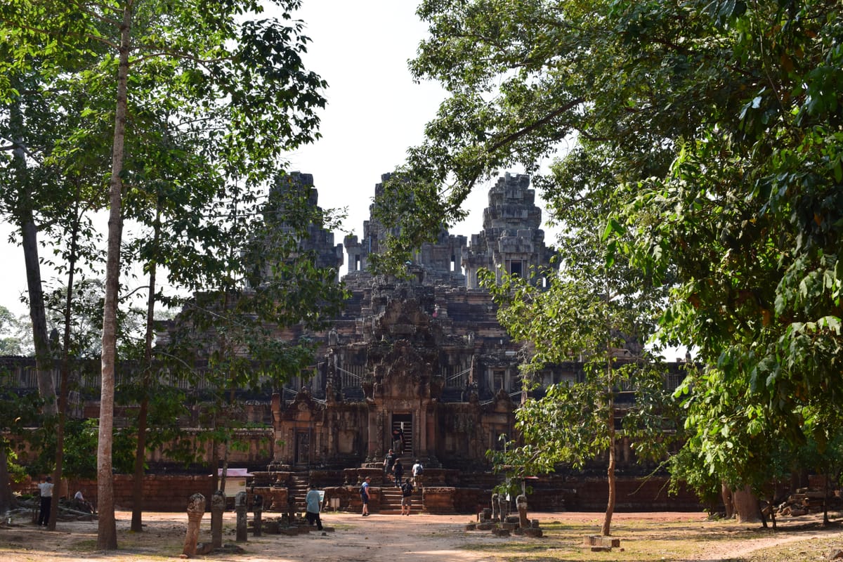 Ta Keo viewed from the surrounding courtyard, its plain stacked sandstone blocks visible across the temple's face.