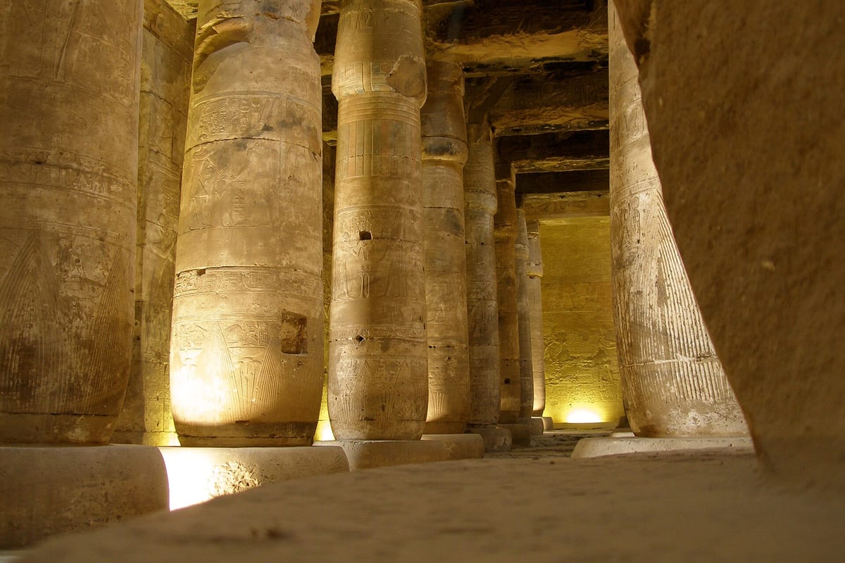 Inside one of the temple's two hypostyle halls, whose closely spaced columns carry carved and painted decoration and once supported a stone roof.