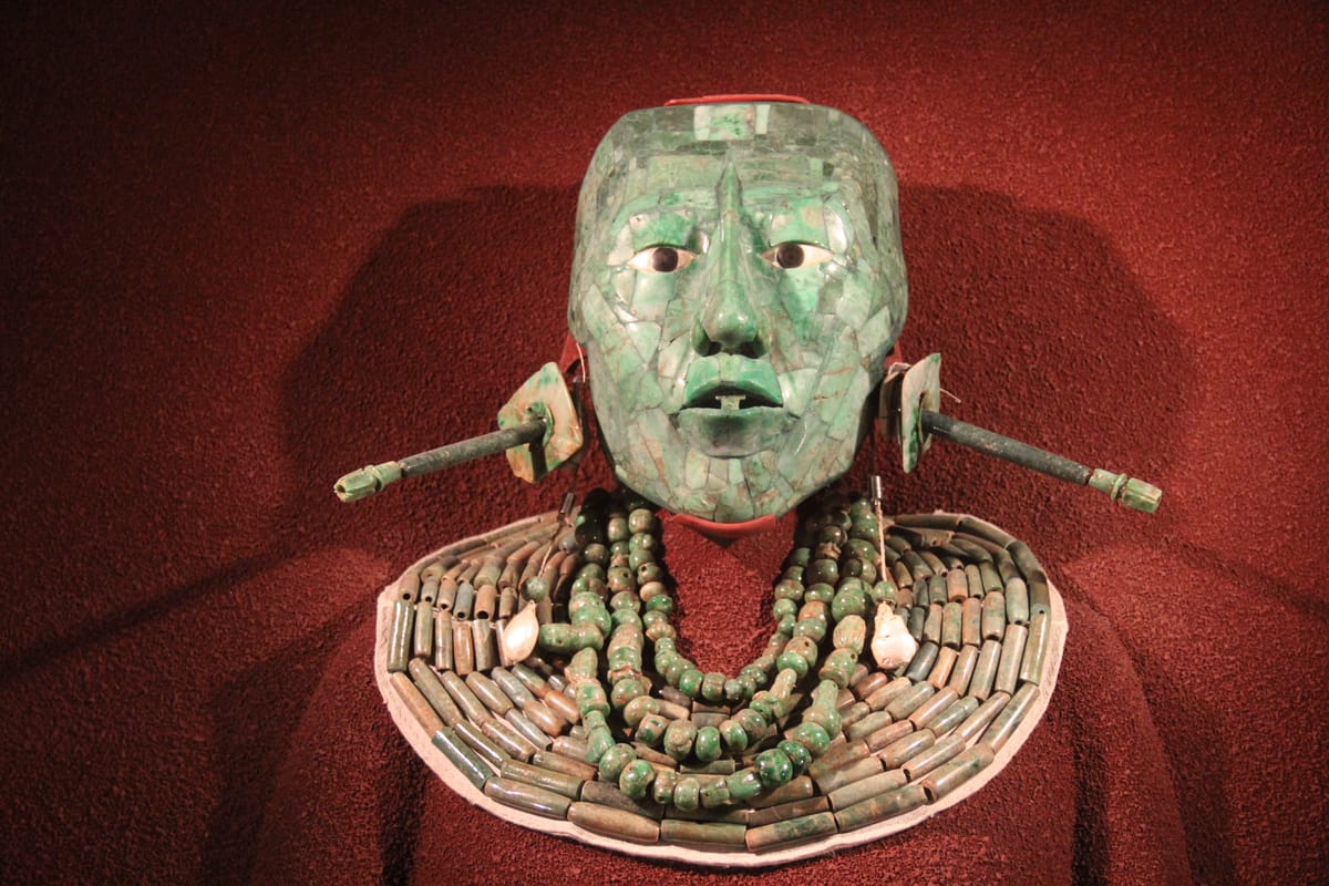 Pakal's funerary mask — a mosaic of jade with eyes of shell, mother-of-pearl and obsidian — with the jade collar found on the body. Now in the Museo Nacional de Antropología, Mexico City.