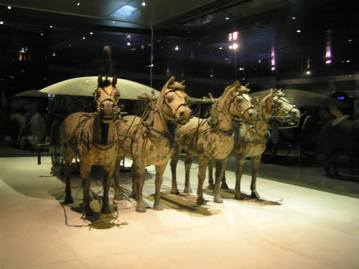One of the two half-size bronze chariots-and-horses found near the tomb, cast and assembled from thousands of fragments — evidence of the same workshops' metalworking skill.