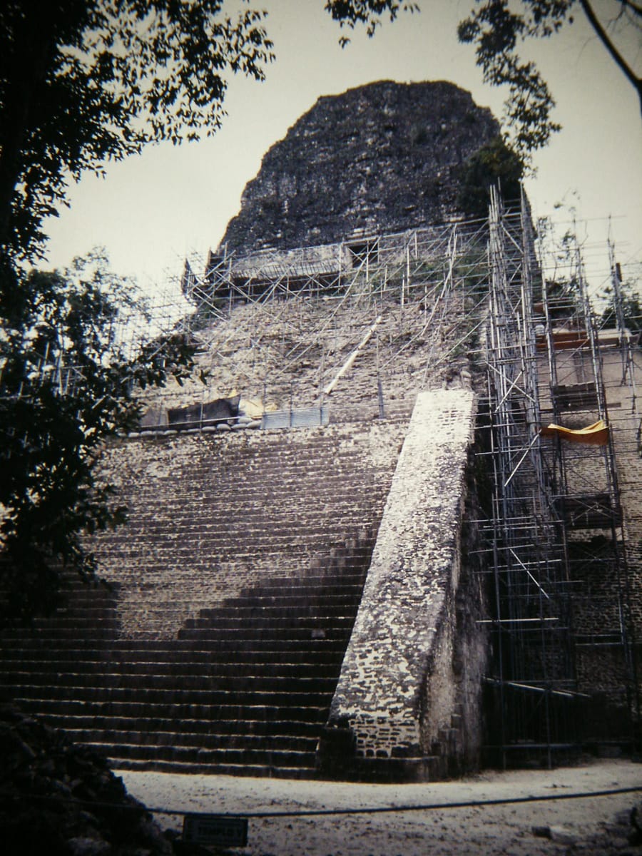 Temple V under scaffolding in April 2002, during the Guatemalan-Spanish restoration campaign that ran from 1998 to 2004 and rebuilt much of the stairway.