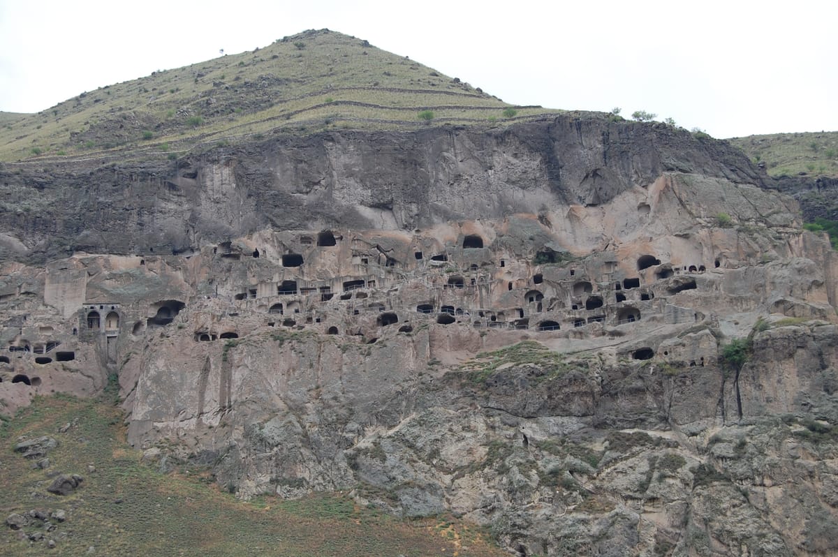 Rock-cut openings and passages across the multi-tiered cave city.