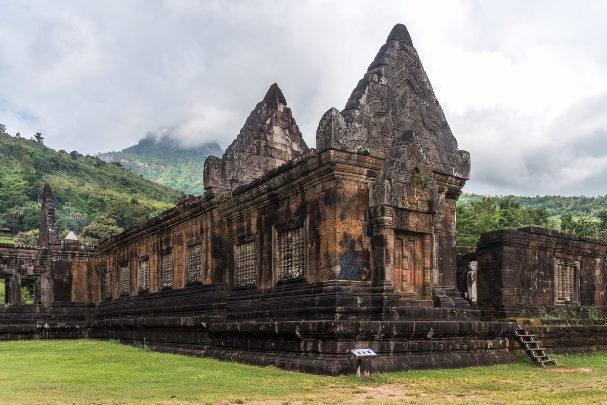 Carved sandstone pediment on the northern quadrangle building, in the Khmer decorative tradition.