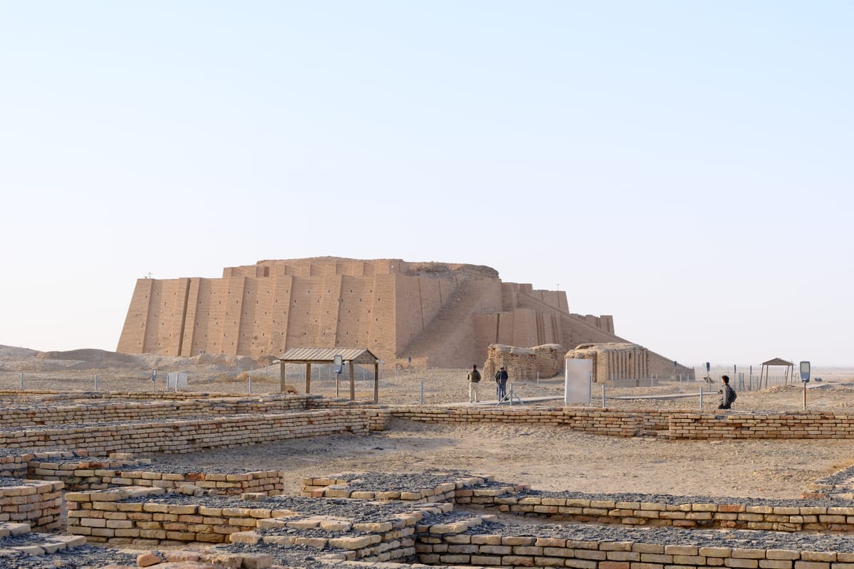 The ziggurat seen across the excavated foundations of Ur. The horizon says everything about the problem the builders faced: a dead-flat alluvial plain with no stone, no timber and no high ground anywhere in sight.